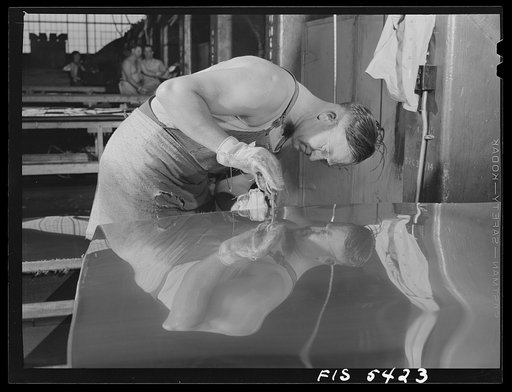 Sheffield, Alabama. Reynolds Alloys Company. Workman gauging the thickness of a sheet of aluminum which he is rolling