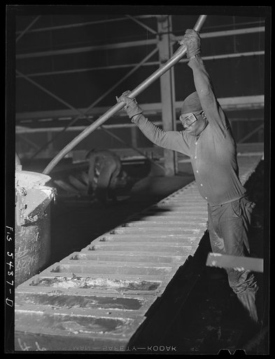 Untitled photo, possibly related to: Sheffield, Alabama. Reynolds Metal Company. Pouring aluminum into pig molds at the cast house