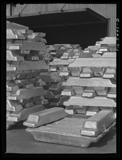 Untitled photo, possibly related to: Sheffield, Alabama. Reynolds Metal Company. Aluminum pigs in the yard outside the cast house