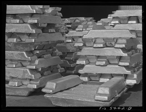 Untitled photo, possibly related to: Sheffield, Alabama. Reynolds Metal Company. Aluminum pigs in the yard outside the cast house
