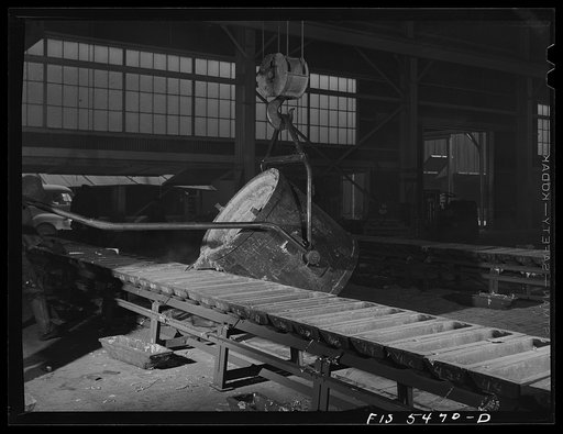Untitled photo, possibly related to: Sheffield, Alabama. Renolds Metal Company. Pouring liquid aluminum into pig molds from a ladle at the dast house