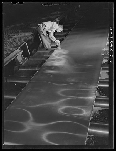 Sheffield, Alabama. Reynolds Alloys Company. Kenneth C. Hall, foreman of the hot mill gauging the thickness of a sheet of aluminum which is being rolled