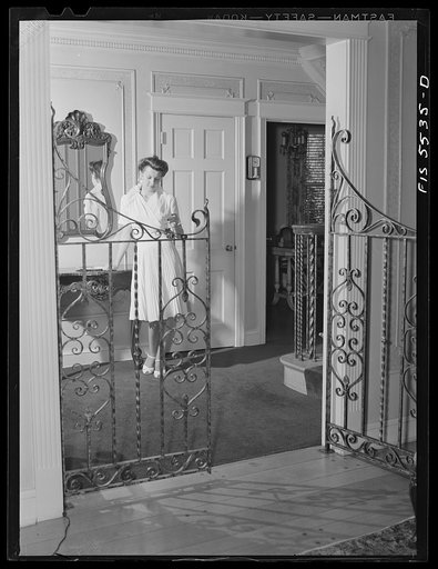 Washington, D.C. The Icelandic legation. Margret Thors reading her mail in the legation hallway