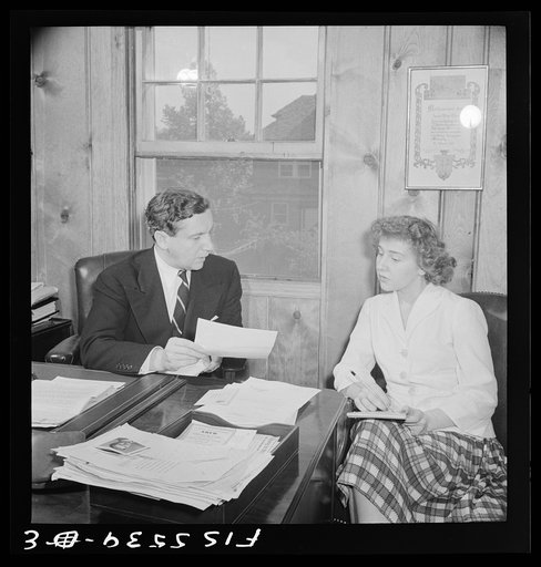 Washington, D.C. The Icelandic legation. Minister Thors dictating a letter to his niece Martha Thors, who is his secretary, in his office in the chancery. His home may be seen out the window