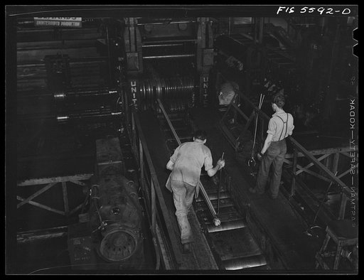 Sheffield, Alabama. Reynolds Alloys Company. Rolling aluminum rod on the tilt-table in the structural mill