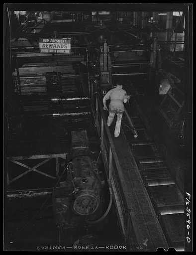 Untitled photo, possibly related to: Sheffield, Alabama. Reynolds Alloys Company. Rolling aluminum rod on the tilt-table in the structural mill