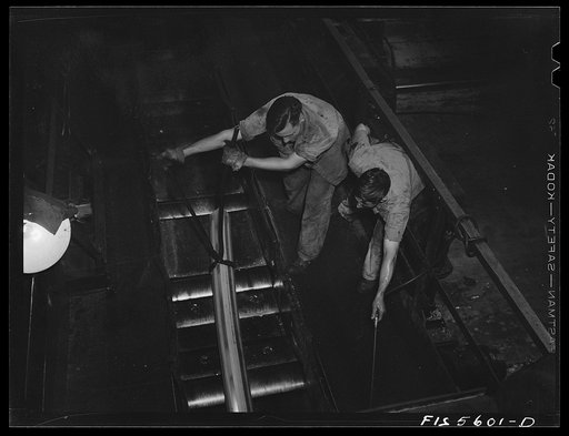 Untitled photo, possibly related to: Sheffield, Alabama. Reynolds Alloys Company. On the tilt-table of a rolling machine in the structural mill
