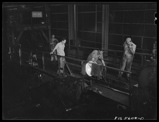 Sheffield, Alabama. Reynolds Alloys Company. Checking the thickness of aluminum rod being rolled in the structural mill