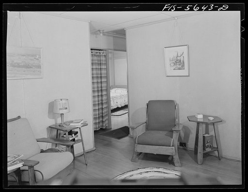 Middle River, Maryland. Housing development for workers at the Glenn L. Martin aircraft plant. Corner of a living room with wide view of a bedroom showing doorless closet in the hall. The only doors are for the bedrooms