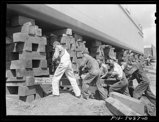 Ingalls Shipbuilding Company, Decatur, Alabama. Removing the timbers which support an Army barge, just before launching her