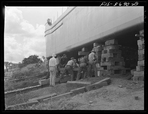 Ingalls Shipbuilding Company, Decatur, Alabama. Removing the timbers which support an Army barge, just before launching her