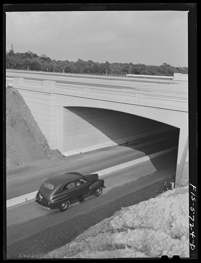 Untitled photo, possibly related to: Pennsylvania Turnpike, Pennsylvania. A car leaving the turnpike at the side exit uses the underpass