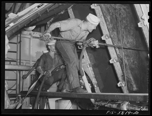 Hoffman Island, merchant marine training center off Staten Island, New York. Trainees cleaning out boilers aboard the training ship New York