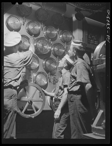 Hoffman Island, merchant marine training center off Staten Island, New York. Instructor with trainees as the main control board in the engine room of the training ship New York