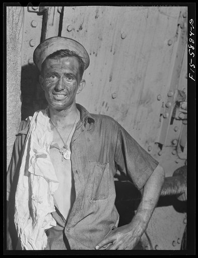Hoffman Island, merchant marine training center off Staten Island, New York. Trainee working in boiler room of the training ship New York