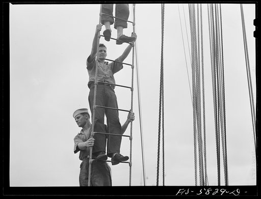 Untitled photo, possibly related to: Hoffman Island, merchant marine training center off Staten Island, New York. Trainee climbing to the tops of the schooner Vema on which they have a month's training