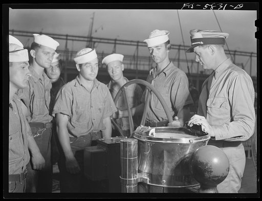 Hoffman Island, merchant marine training center off Staten Island, New York. Mr. Stone instructing trainees in piloting at the wheel of the schooner Vema