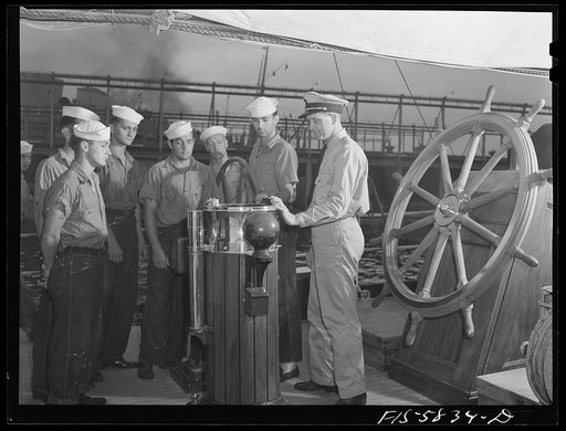 Hoffman Island, merchant marine training center off Staten Island, New York Mr. Stone instructing trainees in piloting at the wheel of the schooner Vema