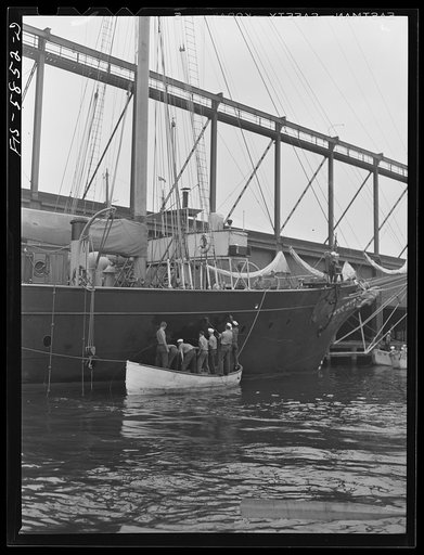 Trainees painting the schooner Vema at Pier 18, Staten Island, New York. The Vema was assigned to the nearby merchant marine training center at Hoffman Island