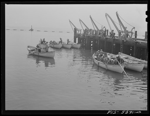 Untitled photo, possibly related to: Hoffman Island, merchant marine training center off Staten Island, New York. Lowering the life boats for drill