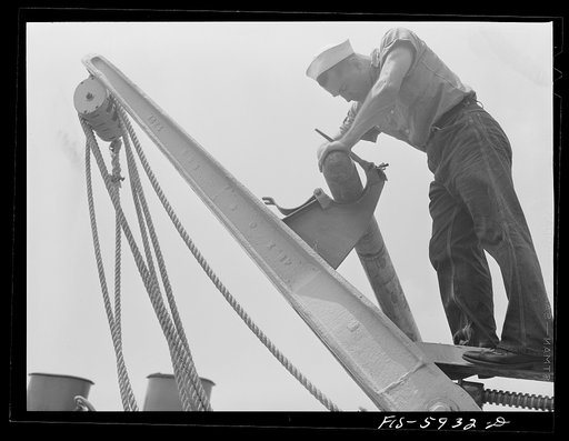 Hoffman Island, merchant marine training center off Staten Island, New York. Member of the bull gang painting davit. All trainees spend one week on the bull gang, doing work of all kinds