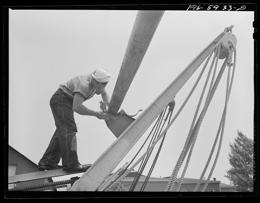 Hoffman Island, merchant marine training center off Staten Island, New York. Member of the bull gang painting davit. All trainees spend one week on the bull gang, doing work of all kinds