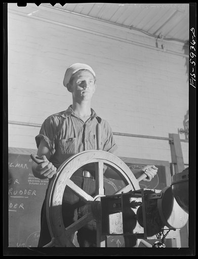 Hoffman Island, merchant marine training center off Staten Island, New York. Trainee at ship's wheel in the class room