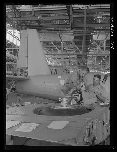 Untitled photo, possibly related to: Nashville, Tennessee. Installing landing gears in wing section. Vultee Aircraft Corporation plant