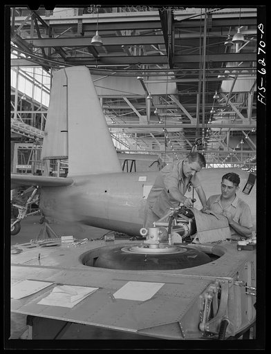 Nashville, Tennessee. Installing landing gears in wing section. Vultee Aircraft Corporation plant