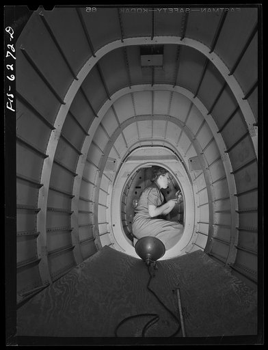 Nashville, Tennessee. Girl riveter in the bomber fuselage. Vultee Aircraft Corporation plant