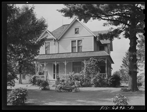 Vernon County, Wisconsin. Home of E.J. Saugstad. Mrs. Saugstad and neighbors are braiding a rug