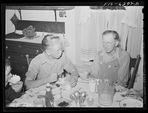 Vernon County, Wisconsin. Eddie Saugstad and son Robert at dinner