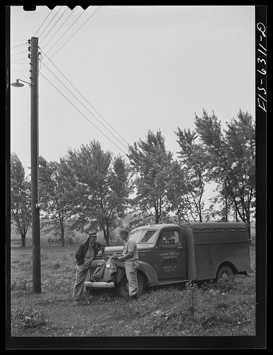 Vernon County, Wisconsin. Eddie Saugstad, member of the U.S. Rural Electrification Administration (REA) cooperative talking to a maintenance man