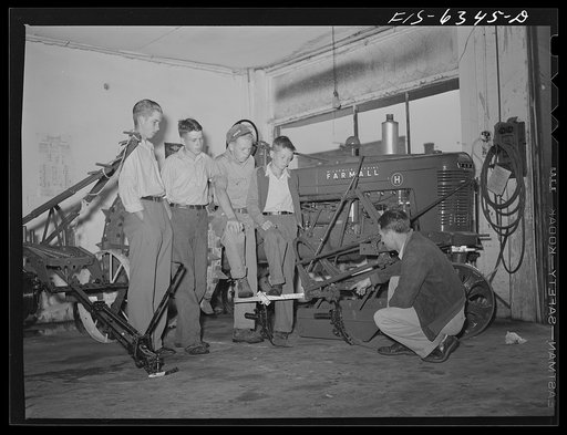 Untitled photo, possibly related to: Vernon County, Wisconsin. Robert Saugstad with the Future Farmers of America (FFA) group studying the new Farmall tractor