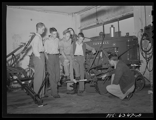 Untitled photo, possibly related to: Vernon County, Wisconsin. Robert Saugstad with the Future Farmers of America (FFA) group studying the new Farmall tractor