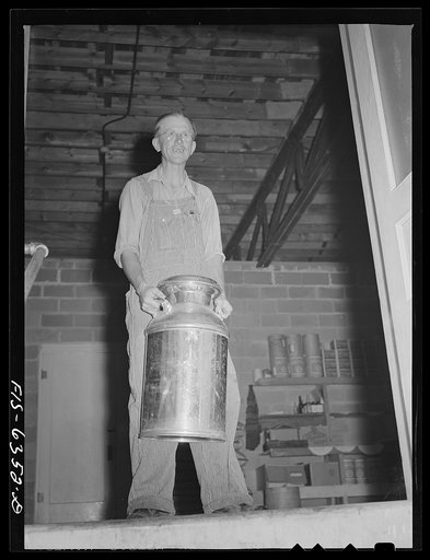 Untitled photo, possibly related to: Vernon County, Wisconsin. Edward Saugstad with a milk can