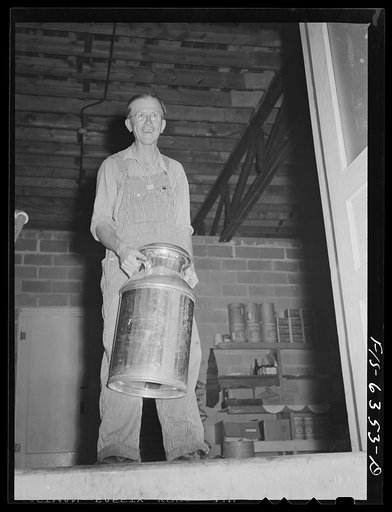 Vernon County, Wisconsin. Edward Saugstad with a milk can