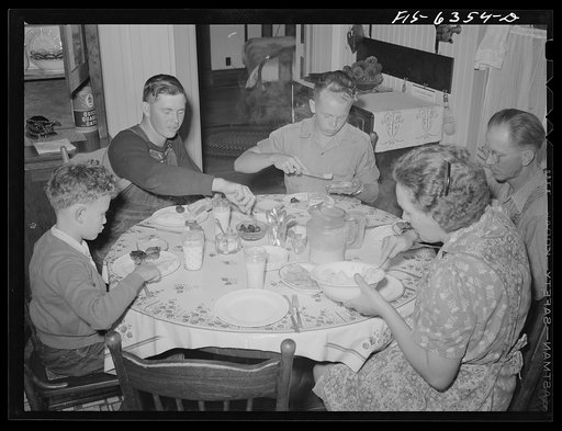 Untitled photo, possibly related to: Vernon County, Wisconsin. Saugstad family at dinner. Left to right: Teddy. Aged ten; Alton Lee, hired man; Robert, aged sixteen, Mr. and Mrs. Saugstad