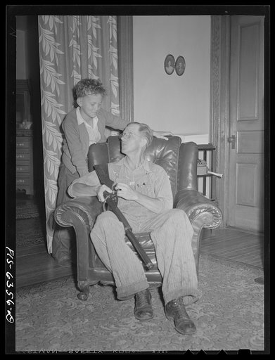 Untitled photo, possibly related to: Vernon County, Wisconsin. Edward Saugstad showing som Teddy how to operate a new rifle