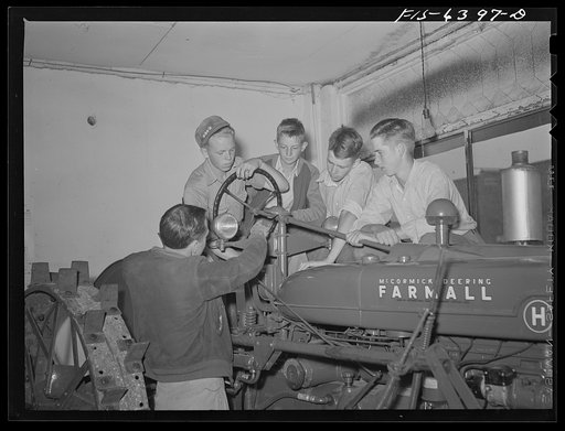Untitled photo, possibly related to: Vernon County, Wisconsin. Robert Saugstad with the Future Farmers of America (FFA) group studying the new Farmall tractor