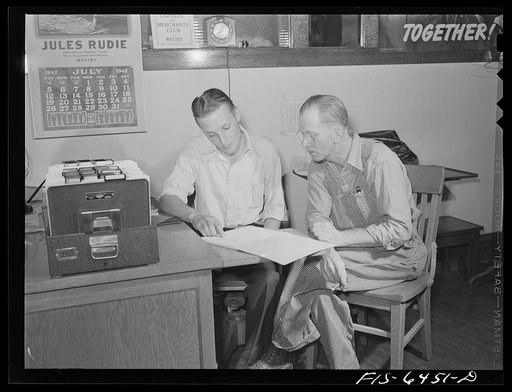 Untitled photo, possibly related to: Westby, Vernon County, Wisconsin. Saugstad is a member of the credit union, a cooperative which loans money to its members. Here he is talking to the bookkeepers in the office