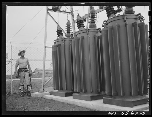 Hayti, Missouri. U.S. Rural Electrification Administration (REA) lineman examining transformers of a substation