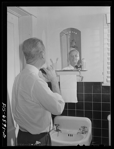 Hayti, Missouri. President of the U.S. Rural Electrification Administration (REA) cooperative using an electric shaver