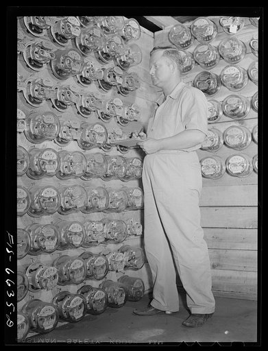 Hayti, Missouri. U.S. Rural Electrification Administration (REA) maintenance man checking electric meters