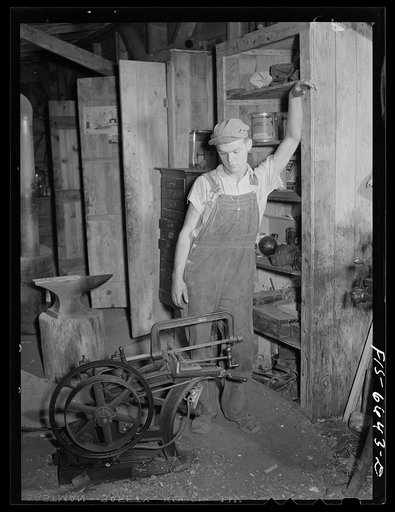 Dunklin County, Missouri. U.S. Rural Electrification Administration (REA) electricity operating a hacksaw on a farm