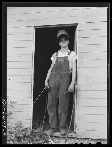 Dunklin County, Missouri. Farm boy using welding equipment with U.S. Rural Electrification Administration (REA) power