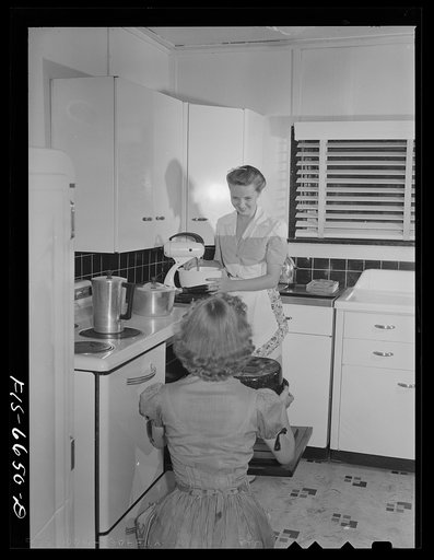 Untitled photo, possibly related to: Dunklin County, Missouri. Daughters of a U.S. Rural Electrification Administration (REA) cooperative member using electric appliance in their farm kitchen