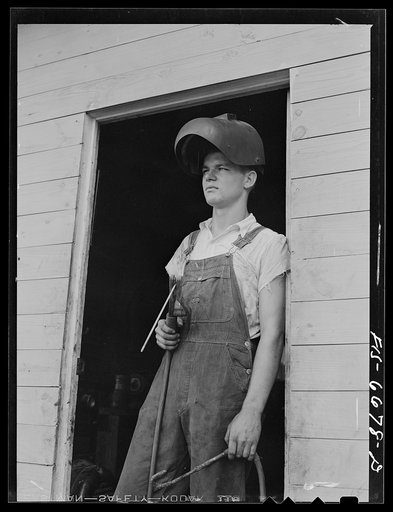 Untitled photo, possibly related to: Dunklin County, Missouri. Farm boy using welding equipment with U.S. Rural Electrification Administration (REA) power