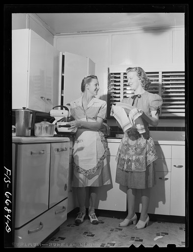 Untitled photo, possibly related to: Dunklin County, Missouri. Daughters of a U.S. Rural Electrification Administration (REA) cooperative member using electric appliance in their farm kitchen