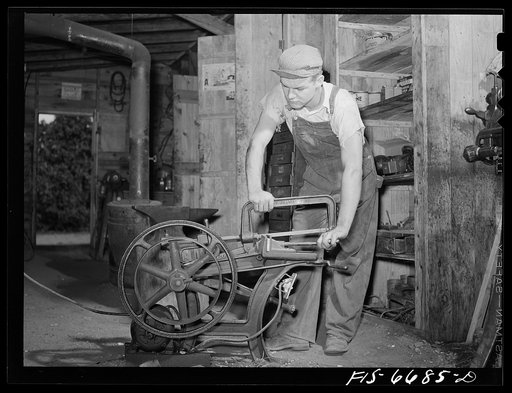Dunklin County, Missouri. Operating a hacksaw on a farm using U.S. Rural Electrification Administration (REA) power